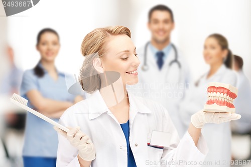 Image of doctor with big jaws and toothbrush