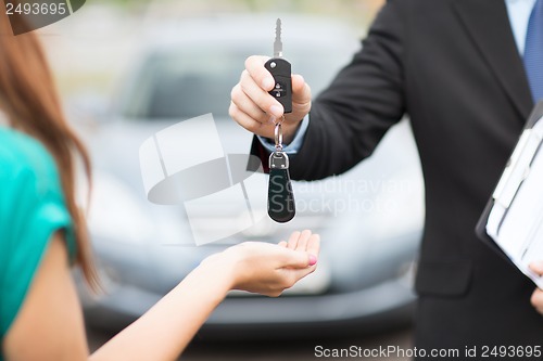 Image of customer and salesman with car key