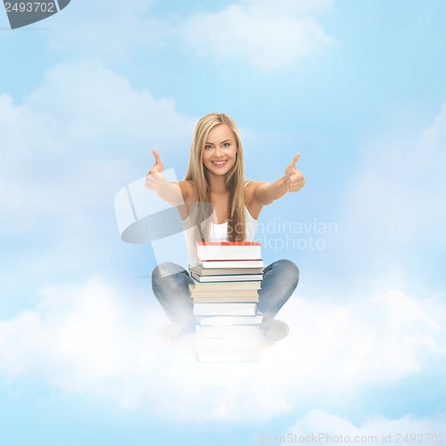 Image of student with stack of books