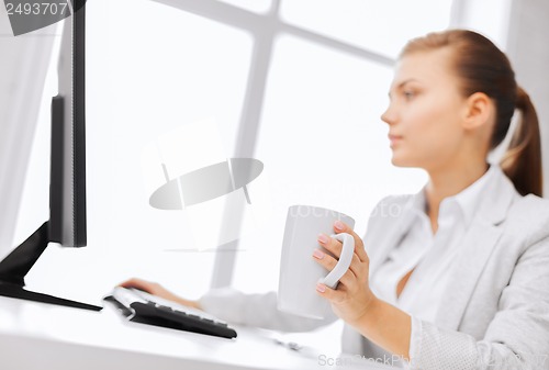 Image of businesswoman with computer in office