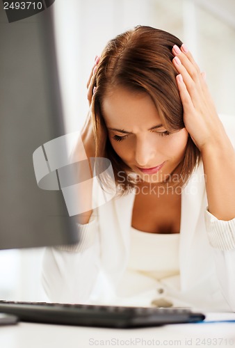 Image of stressed woman with computer