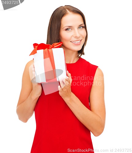 Image of smiling woman in red dress with gift box