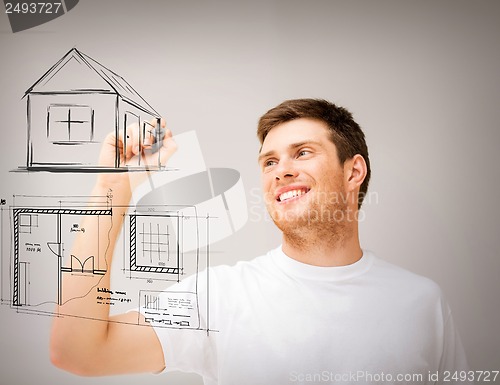 Image of man drawing blueprint on virtual screen