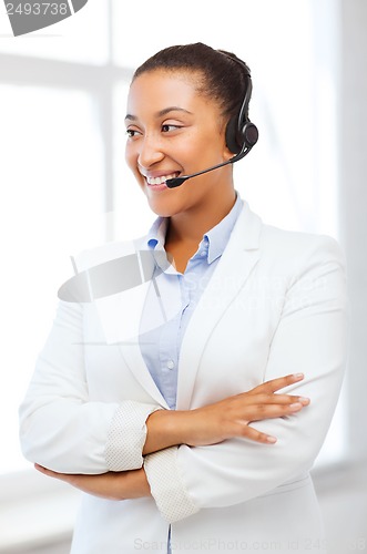 Image of african helpline operator with headphones