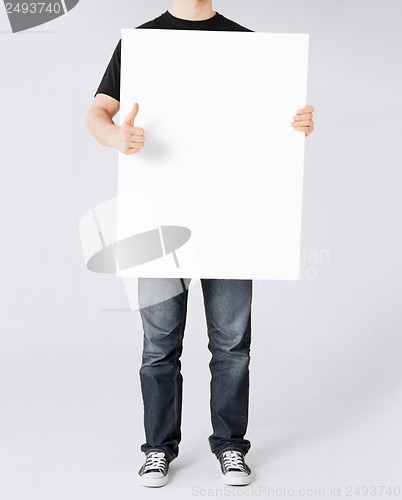 Image of man showing white blank board and thumbs up