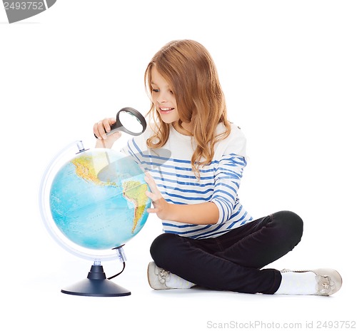 Image of child looking at globe with magnifier
