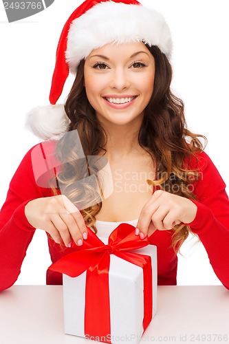 Image of smiling woman in santa helper hat with gift box