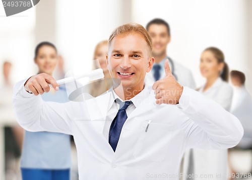 Image of dentist with toothbrush in hospital