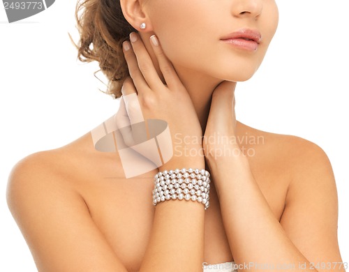 Image of beautiful woman with pearl earrings and bracelet