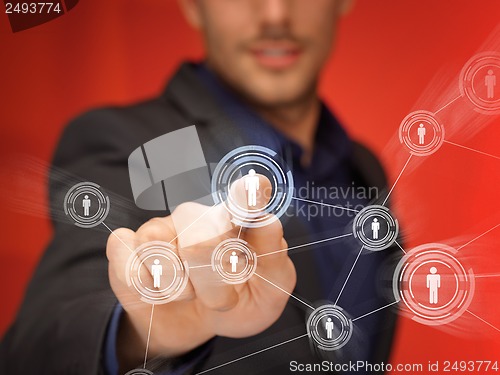 Image of businessman pressing button with contact