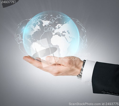 Image of hand holding virtual sphere globe