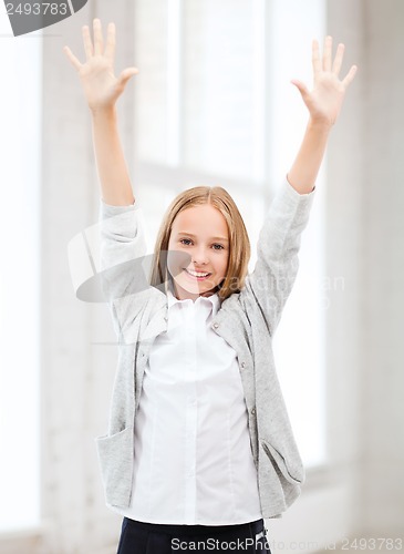 Image of student girl with hands up at school