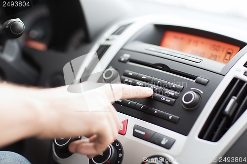 Image of man using car audio stereo system