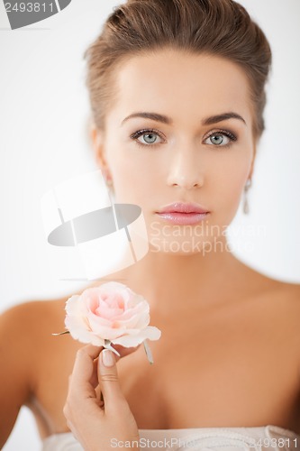 Image of young woman with rose flower