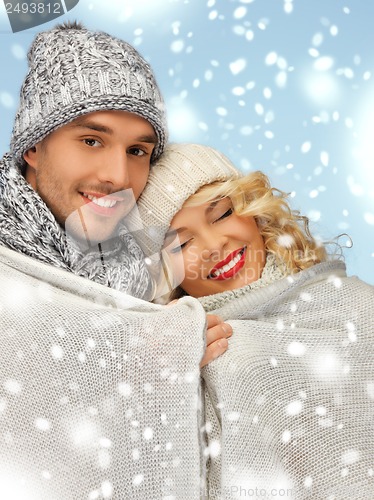 Image of family couple under warm blanket