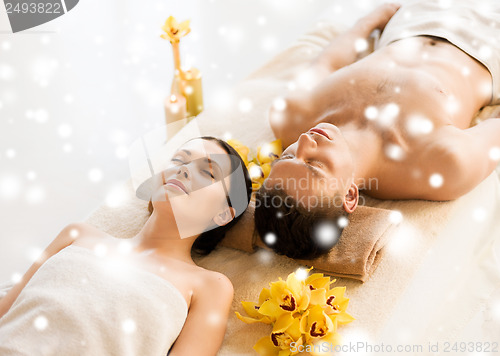 Image of couple in spa salon lying on the massage desks