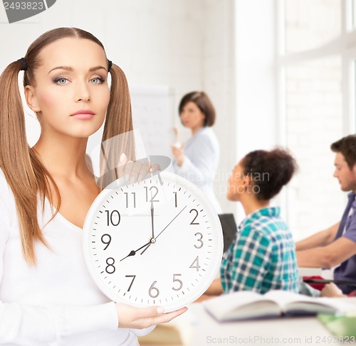 Image of student showing clock