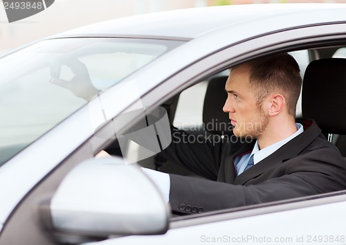 Image of businessman driving a car