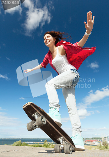 Image of teenage girl skating outside