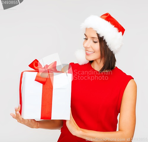 Image of smiling woman in santa helper hat with gift box