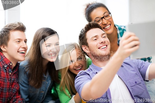 Image of students making picture with tablet pc at school