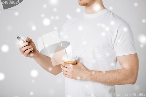 Image of man with smartphone and coffee