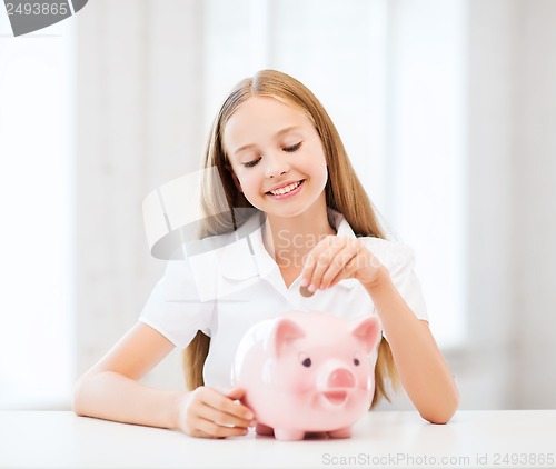 Image of child with piggy bank