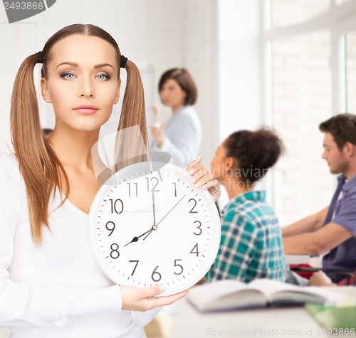 Image of student showing clock