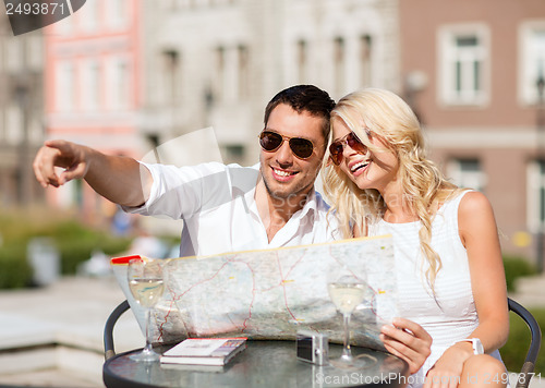 Image of couple with map in cafe