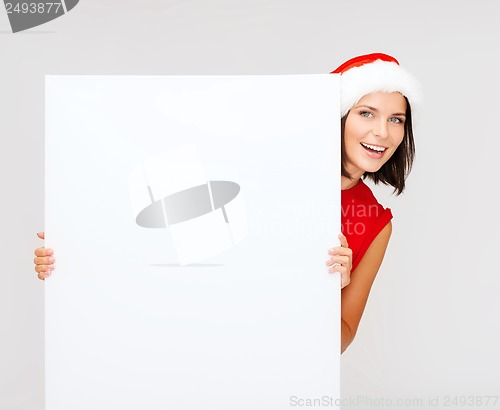 Image of woman in santa helper hat with blank white board