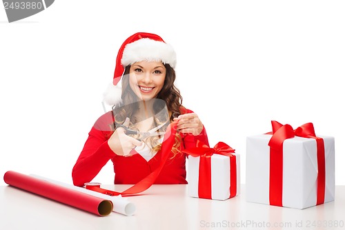 Image of smiling woman in santa helper hat with gift box