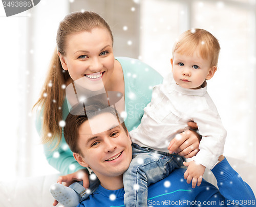 Image of happy parents playing with adorable baby