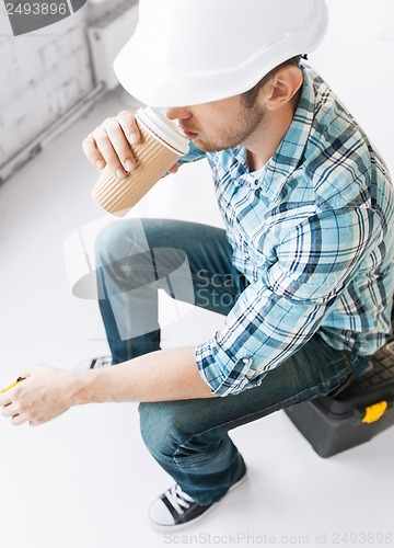 Image of builder drinking take away coffee