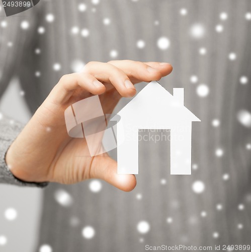 Image of man holding paper house