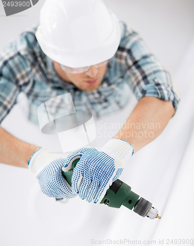 Image of man drilling the wall