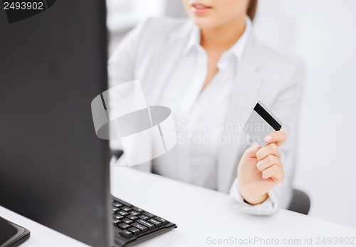 Image of businesswoman with laptop and credit card