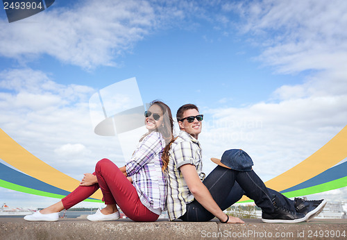 Image of teenagers sitting back to back