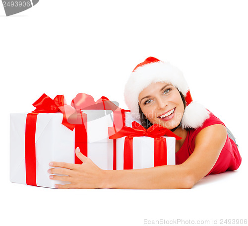 Image of smiling woman in santa helper hat with gift boxes