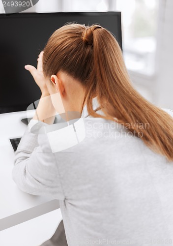 Image of stressed woman with computer