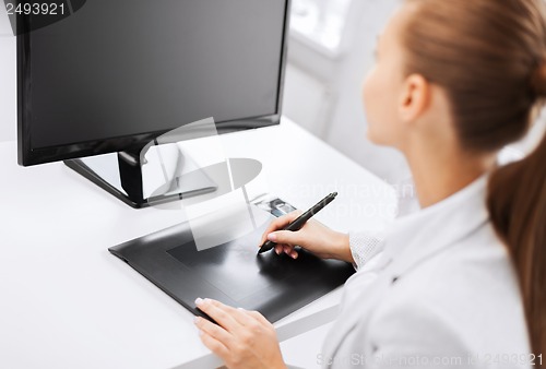 Image of businesswoman with drawing tablet in office