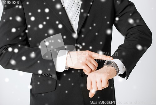 Image of man looking at wristwatch