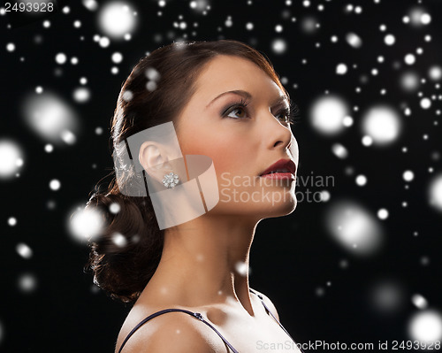 Image of woman in evening dress wearing diamond earrings