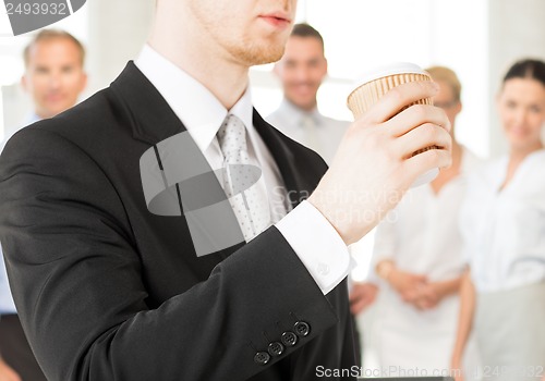 Image of man hand holding take away coffee