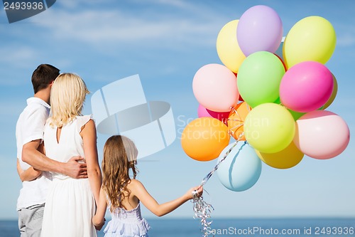 Image of family with colorful balloons