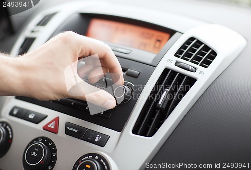 Image of man using car audio stereo system