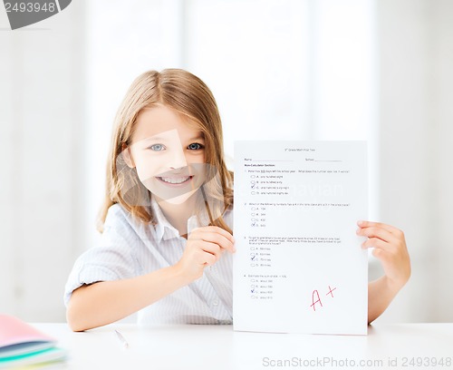 Image of girl with test and A grade at school