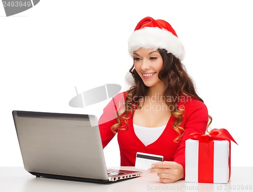 Image of woman with gift, laptop computer and credit card