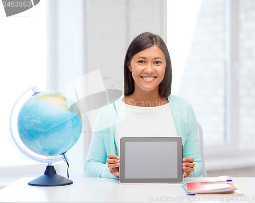 Image of teacher with globe and tablet pc at school