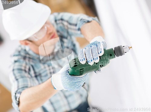 Image of man drilling the wall