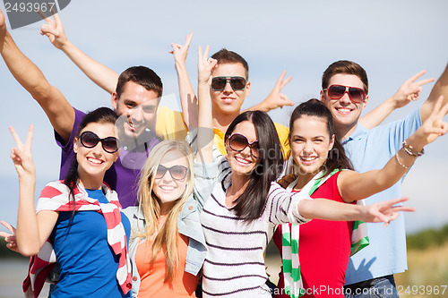 Image of group of friends having fun on the beach